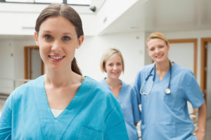 Smart Automations|Smiling nurse with two nurse friends in hospital corridor